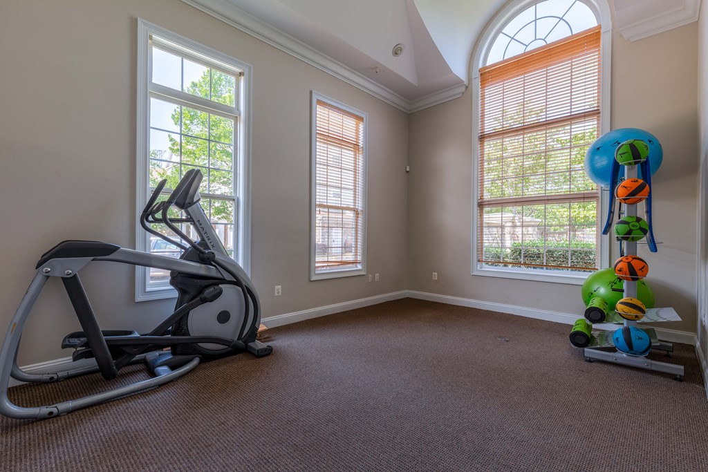 a workout room with an exercise bike and a window
