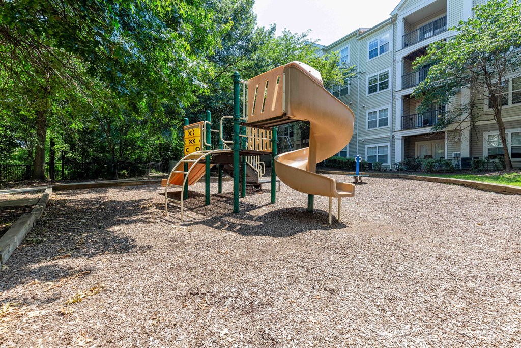 a playground with a slide and other playground equipment in a park