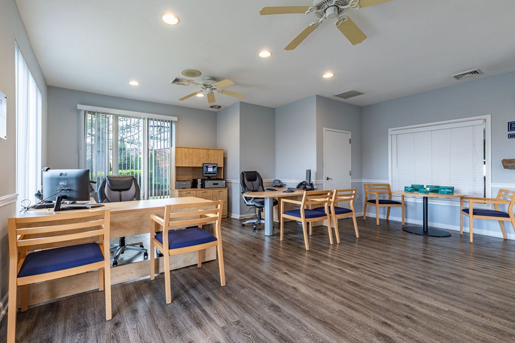 a dining room with tables and chairs and a ceiling fan