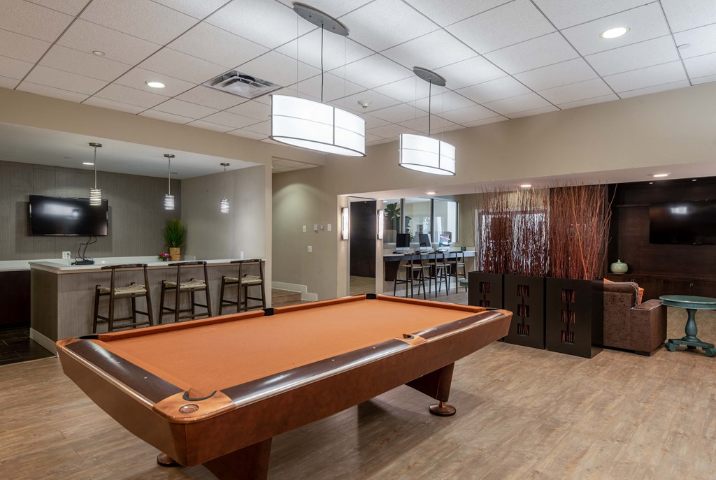 a pool table in a clubhouse with a bar and a tv at Cascade at Landmark, Virginia