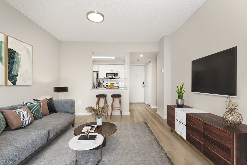 Living room with a couch and a tv at Cascade at Landmark, Alexandria, Virginia