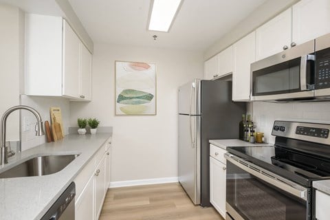 Renovated kitchen with stainless steel appliances and white cabinets  at Cascade at Landmark, Alexandria, 22304