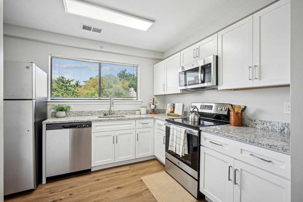 A kitchen with white cabinets and stainless steel appliances at Elme Bethesda, Bethesda, 20814