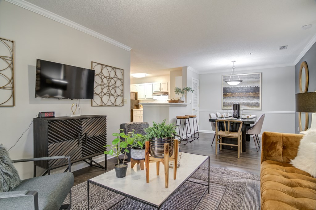 an open living room and dining room with a table and chairs and a television  at Elme Conyers, Georgia, 30013