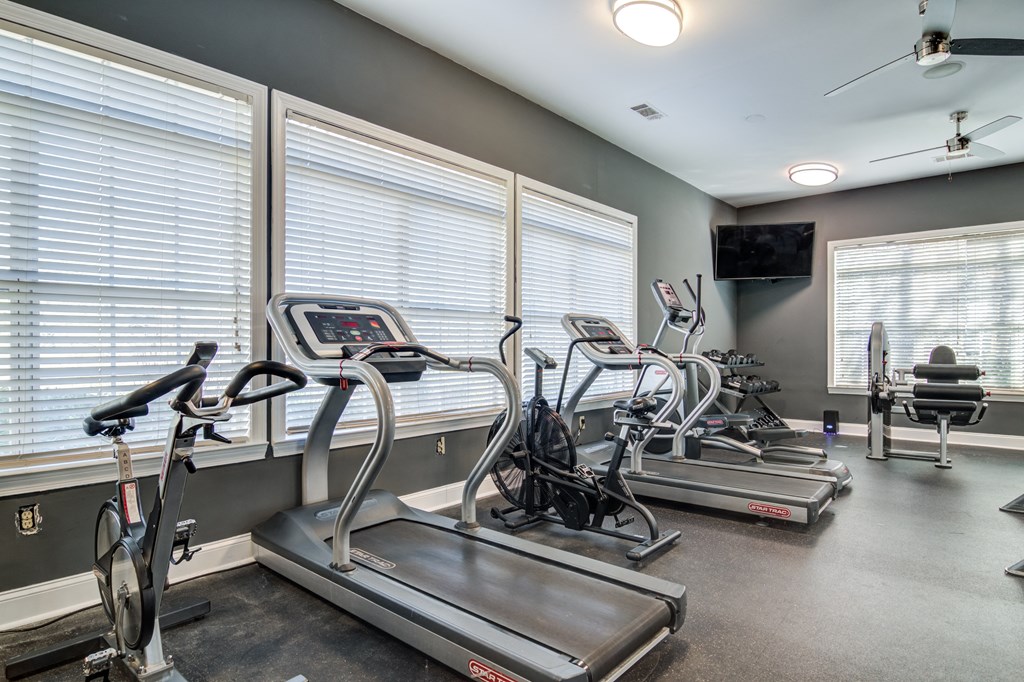 the gym has plenty of exercise equipment and windows at Elme Conyers, Georgia