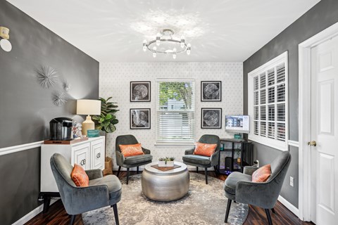 A grey living room with a grey sofa and grey armchairs.