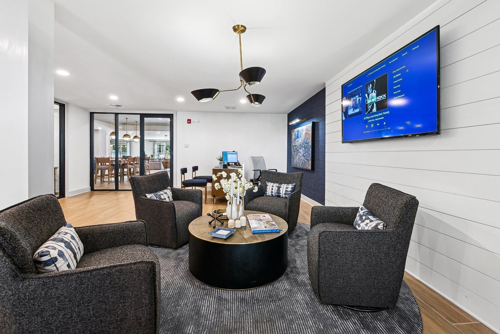 A modern living room with a grey sofa, a black coffee table at Elme Sandy Springs Apartments, Atlanta, GA, 30350