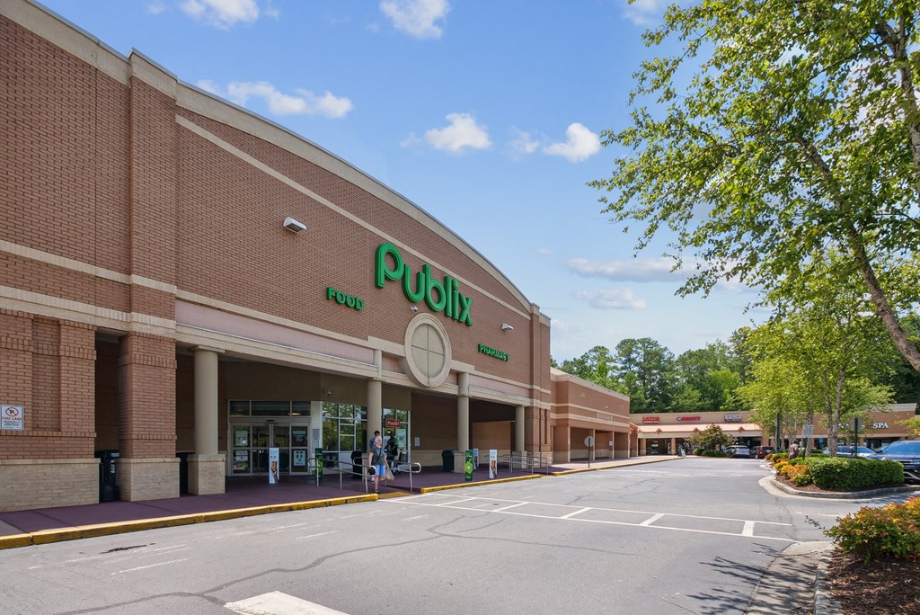A large building with a green sign that says