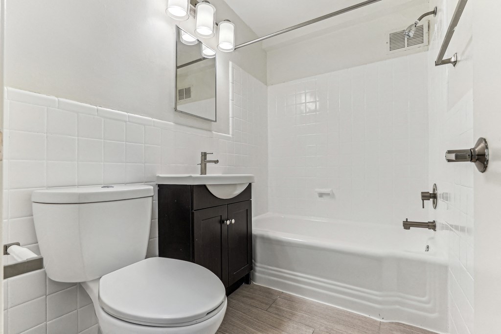 A white bathroom with a toilet, sink, and bathtub at 3801 Connecticut Avenue, Washington, 20008
