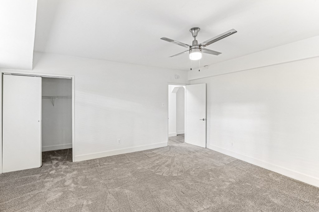 A room with a ceiling fan and carpeted floor at 3801 Connecticut Avenue, Washington, 20008
