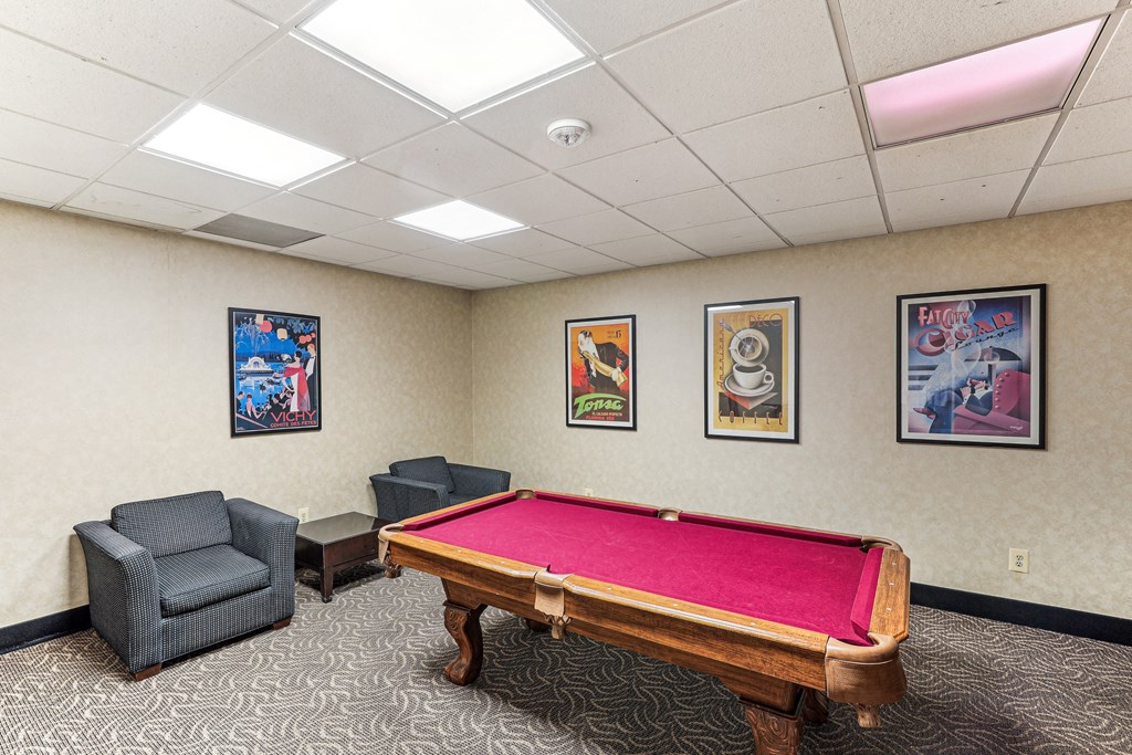 A room with a pool table and three framed pictures on the wall at 3801 Connecticut Avenue, Washington, 20008