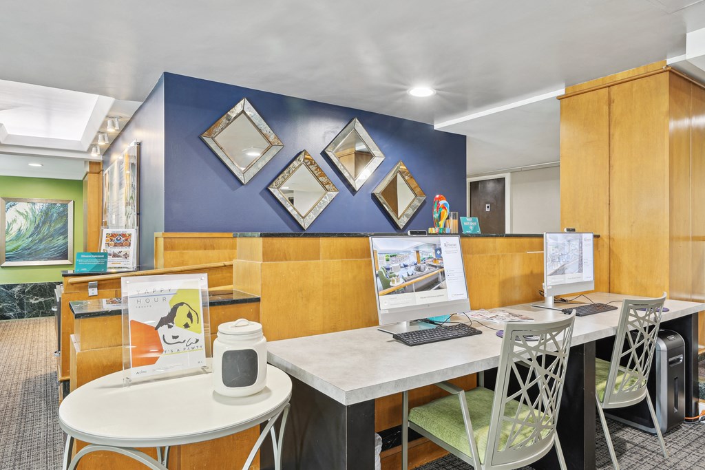 A room with a table, chairs, and a poster on the wall.