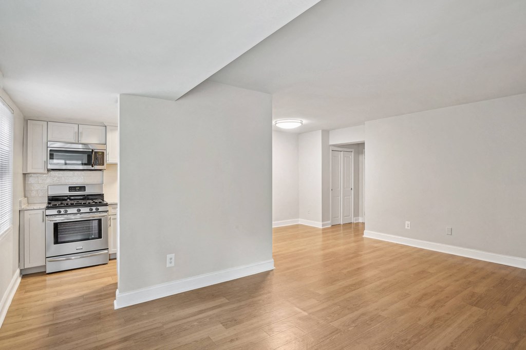 A spacious room with wooden flooring and white walls The Kenmore, Washington, 20015