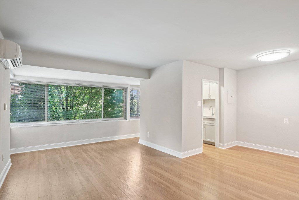 A room with wooden floors and white walls The Kenmore, Washington, 20015