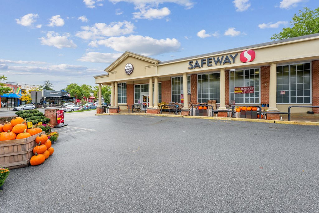 A Safeway store with a parking lot in front.