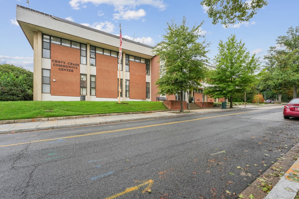 A Chevy Chase Community Center building with a red car parked in front The Kenmore, Washington, 20015