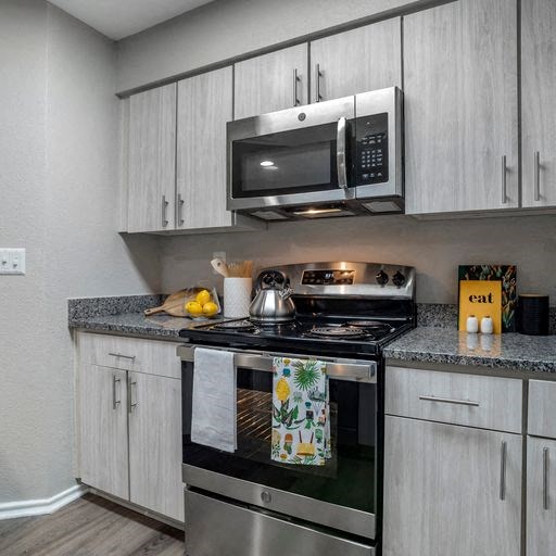 Renovated kitchen with stainless steel appliances and granite countertops at Elme Alexandria, Virginia