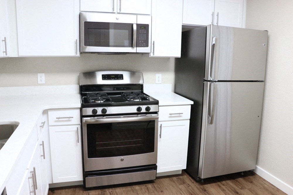 Renovated Kitchen with stainless steel appliances and quartz countertops at Elme Cumberland Apartments, Smyrna, Georgia
