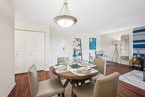 A dining room with a table set for a meal at Riverside Apartments, Alexandria, Virginia