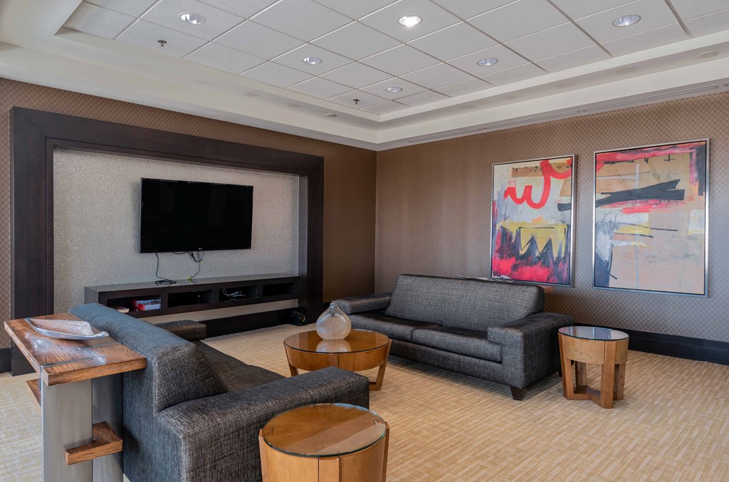 a living room with couches and chairs and a television