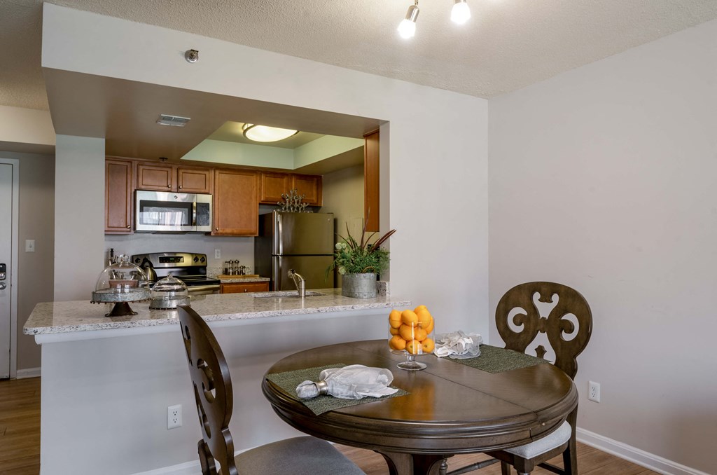 a kitchen and dining room with a table and chairs