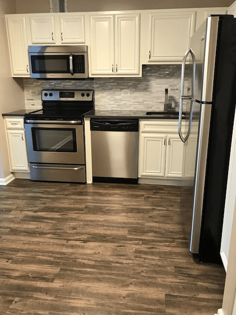 Kitchen with stainless steel appliances and white cabinets at The Ashby at McLean, Virginia, 22101