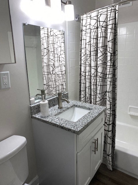 Renovated bathroom with updated vanity and tub at Wellington Apartments, Arlington