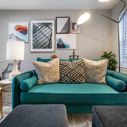 a living room with a green couch and pillows at Elme Alexandria, Alexandria, 22304