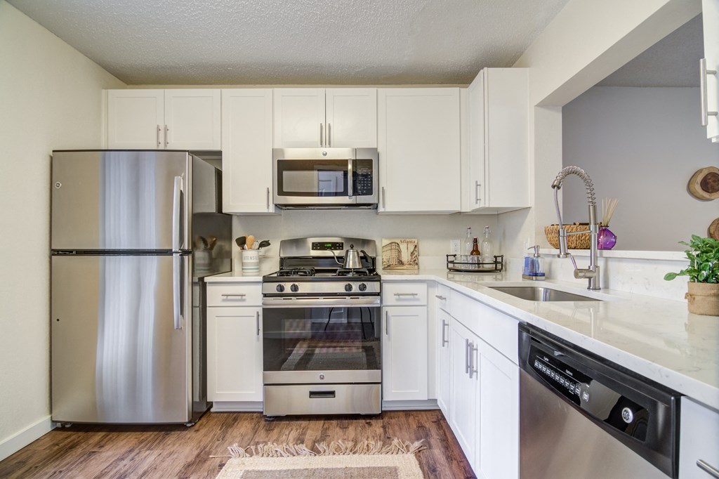 Renovated Kitchen with stainless steel appliances and quartz countertops at Elme Cumberland Apartments, Smyrna, Georgia