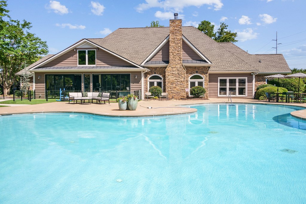 A house with a pool in front of it at Elme Marietta Apartments, Marietta, GA