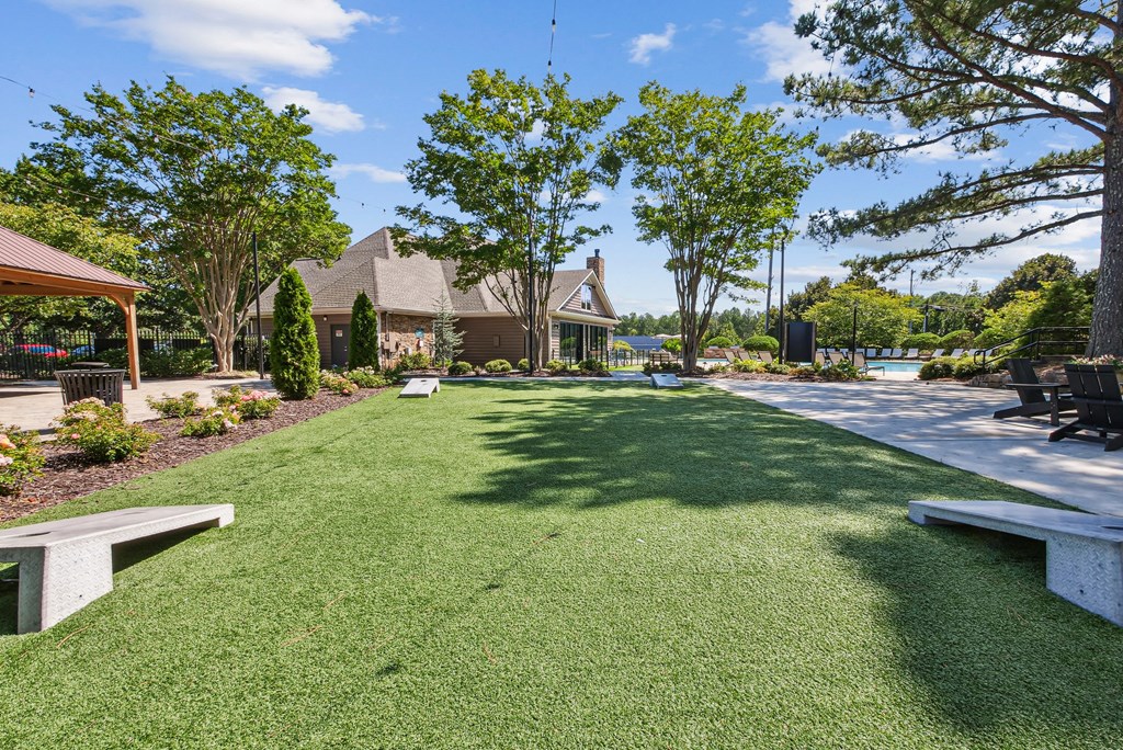 A well-maintained lawn with a house and trees in the backgroundat Elme Marietta Apartments, Marietta, GA