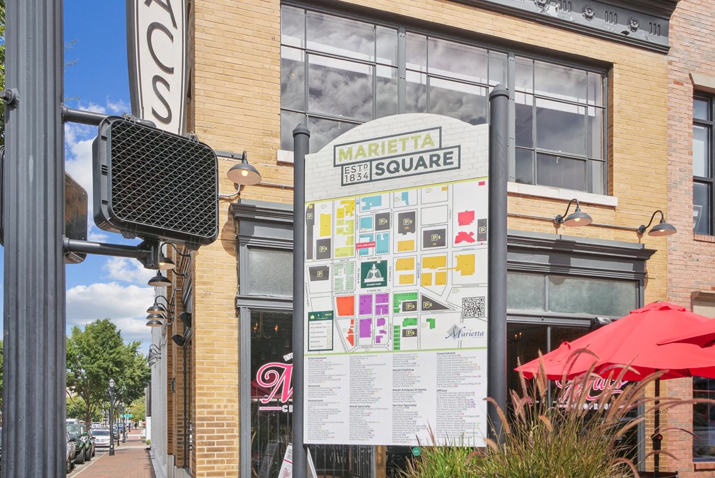A sign for Marietta Square is displayed on a pole in front of a building.