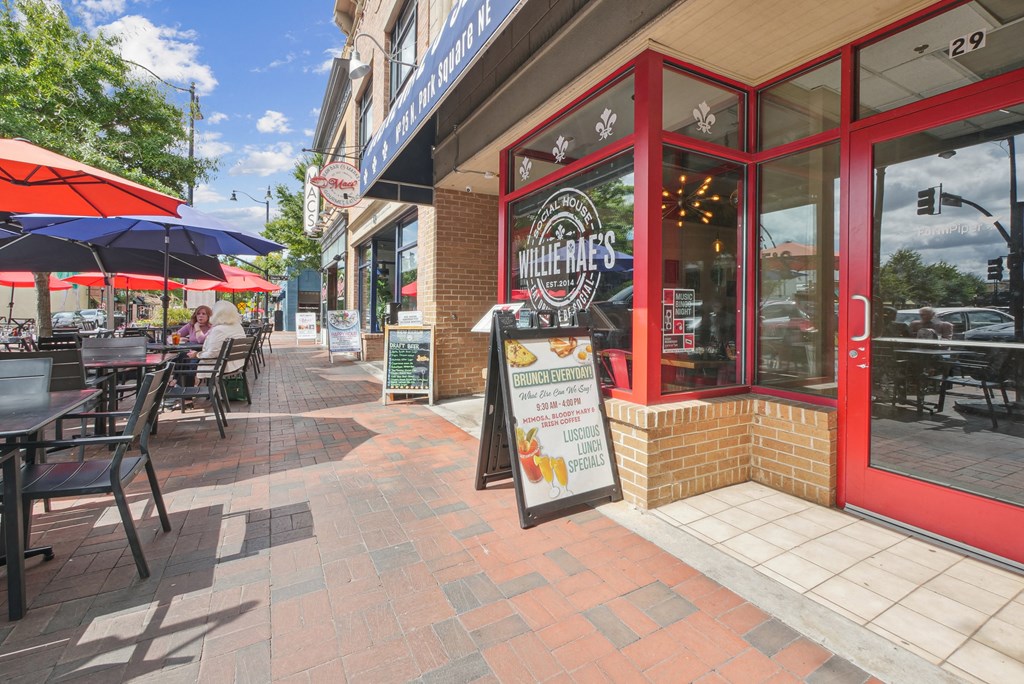A sign for Willey's sits in front of a red building.