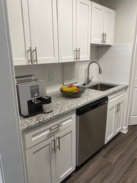 Renovated Kitchen with stainless steel appliances and granite countertops at Wellington Apartments, Arlington