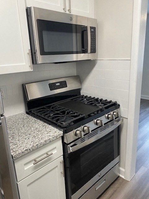Renovated Kitchen with stainless steel appliances and granite countertops at Wellington Apartments, Arlington