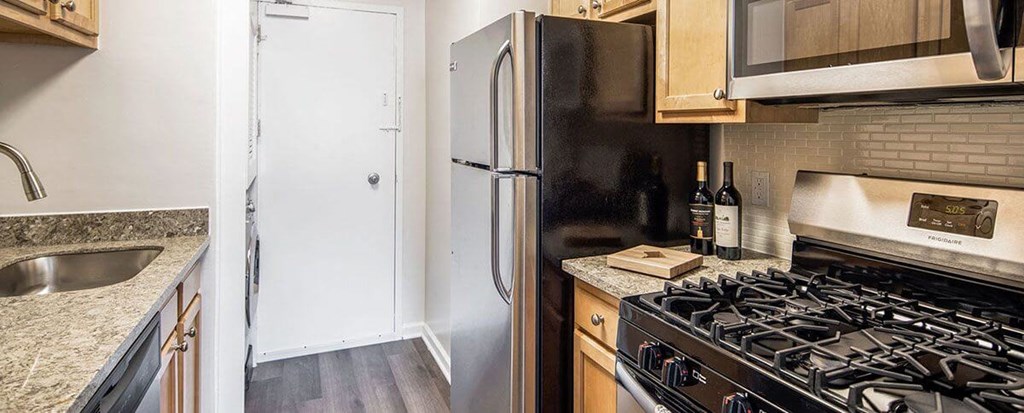 Kitchen with stainless steel appliances and granite countertops at Wellington Apartments, Arlington, Virginia