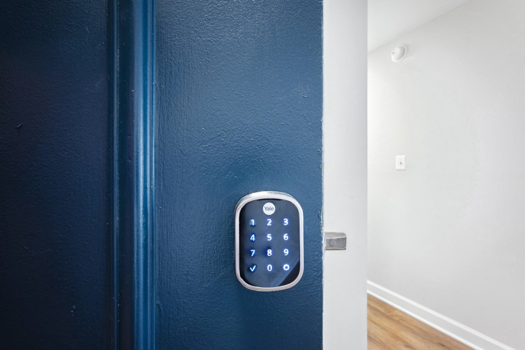 a blue door with smart lock at Roosevelt Towers Apartments, Falls Church, Virginia