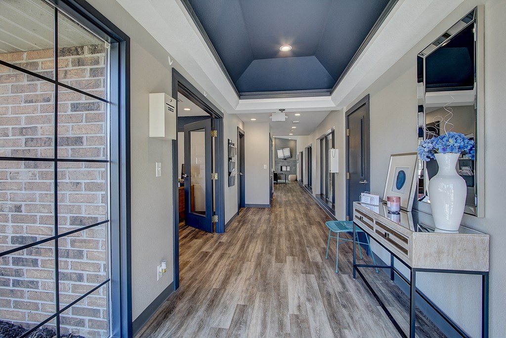 a hallway with a blue ceiling and wood flooring