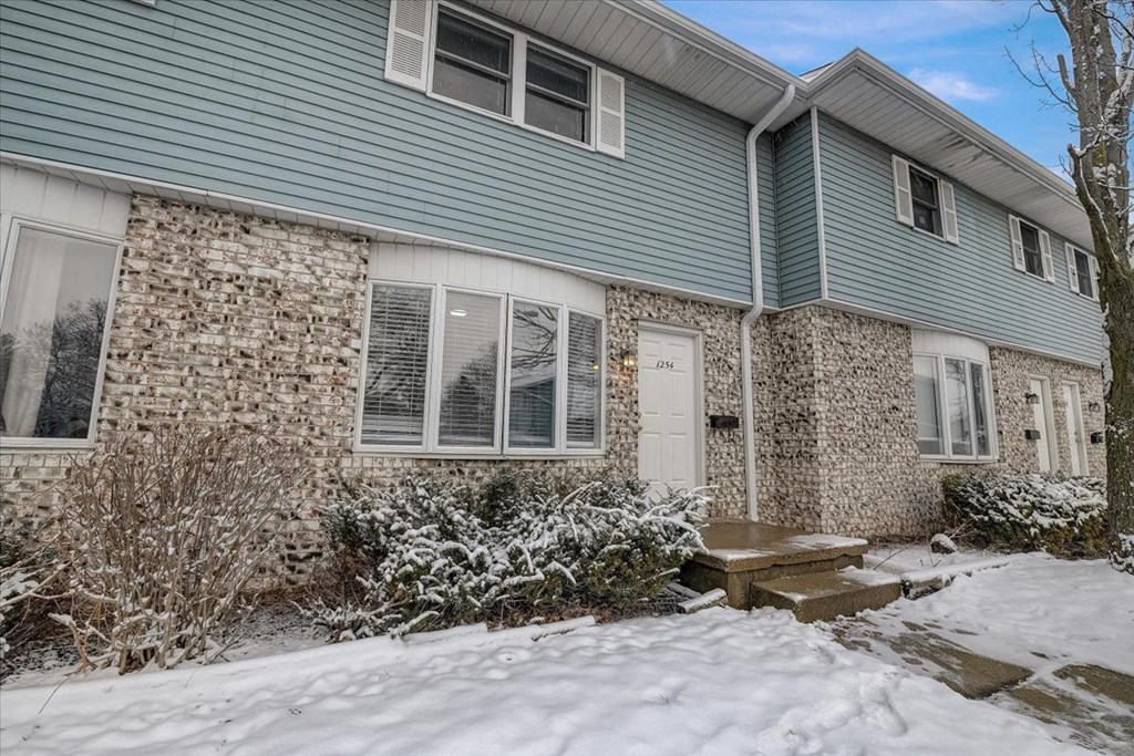 the front of a house with snow on the ground