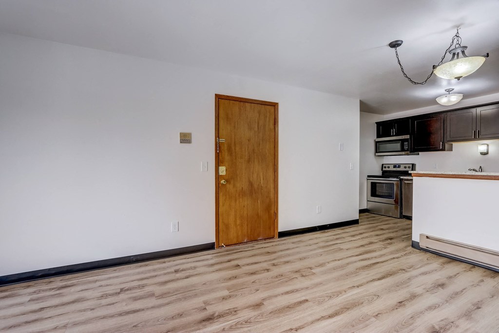 a bedroom with a medium sized window next to a kitchen