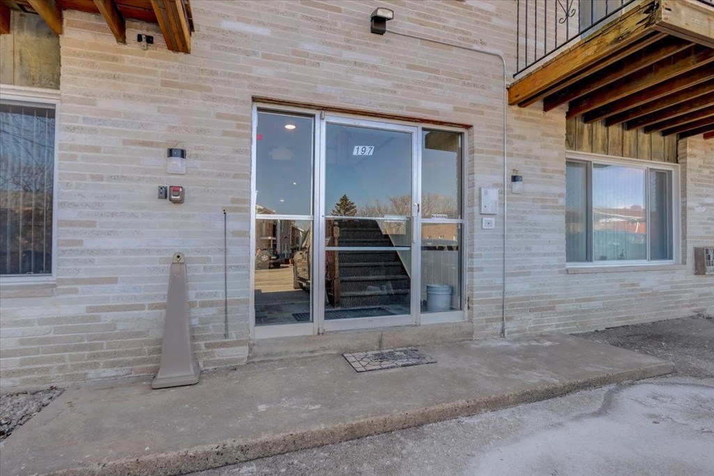 the entrance to a brick building with glass doors