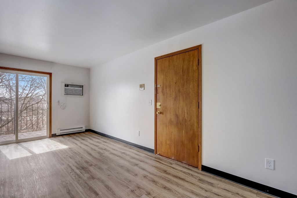 an empty room with a door and a window