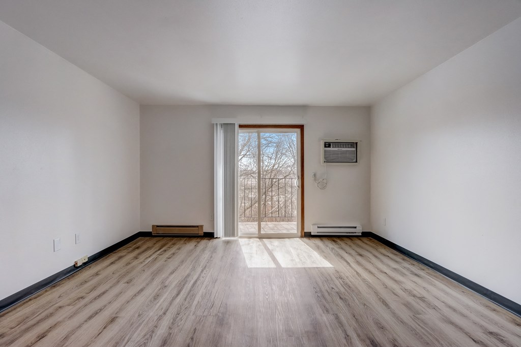 a living room with hardwood floors and white walls