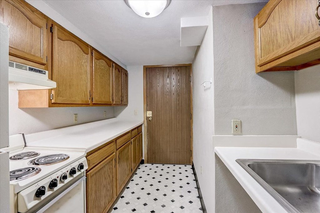 a kitchen with a stove and a sink