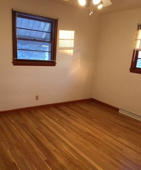 an empty room with a wooden floor and a window