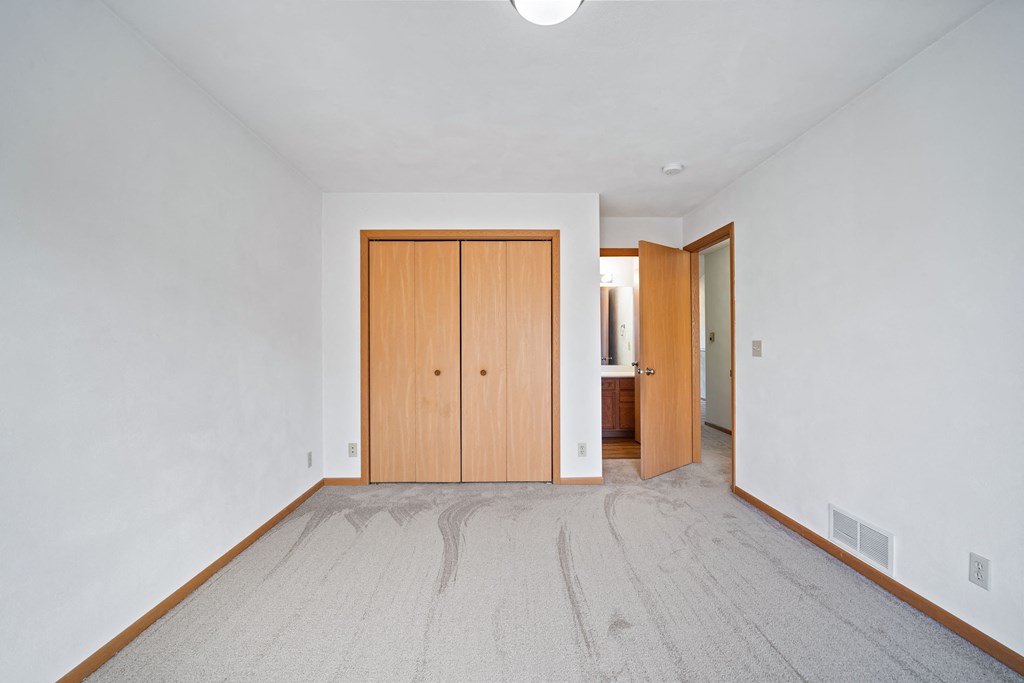 a room with a bathroom and a wooden door