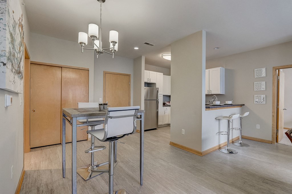 a dining room with a table and chairs and a kitchen