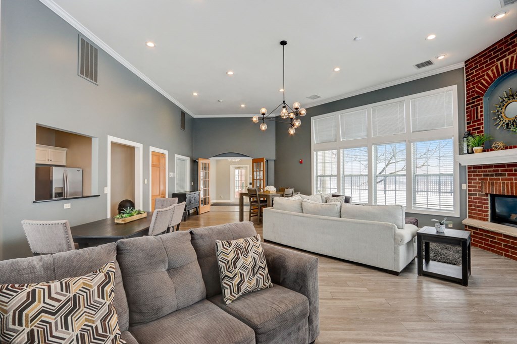 a living room with couches and chairs and a fireplace