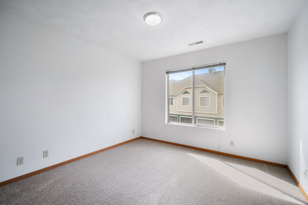 a room with white walls and a window