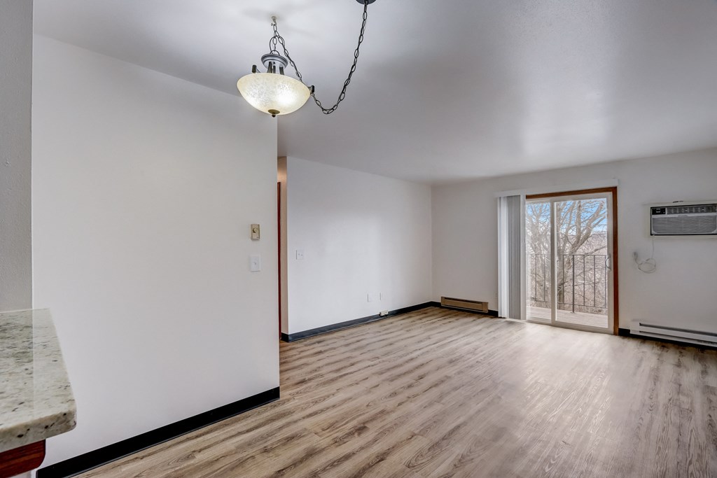 a bedroom with hardwood floors and a sliding glass door